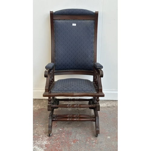 142 - Two pieces of mid/late 20th century mahogany and blue fabric upholstered furniture, one gout stool a... 