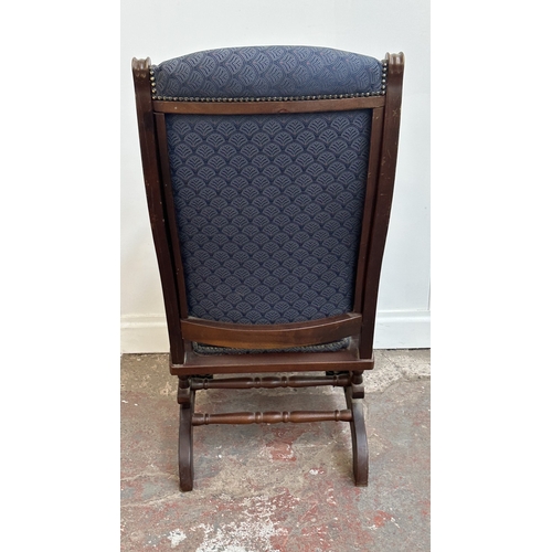 142 - Two pieces of mid/late 20th century mahogany and blue fabric upholstered furniture, one gout stool a... 