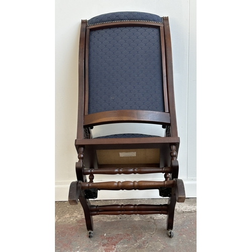 142 - Two pieces of mid/late 20th century mahogany and blue fabric upholstered furniture, one gout stool a... 