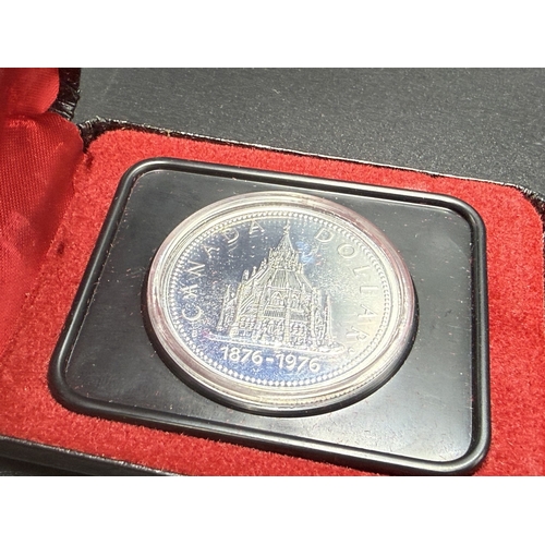 2338 - Two cased Canadian silver coins, one 92.5% 1999 proof 25 cents and one 50% 1976 dollar