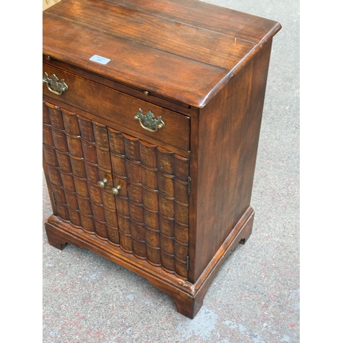 103 - A Theodore Alexander mahogany faux book front side cabinet - approx. 70cm high x 51cm wide x 37cm de... 