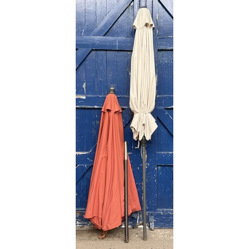 112 - Two garden parasols, one grey metal and beige fabric and one wood and orange fabric - approx. larges... 