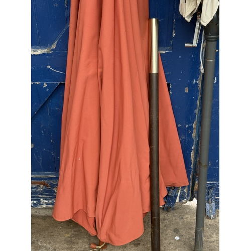 112 - Two garden parasols, one grey metal and beige fabric and one wood and orange fabric - approx. larges... 