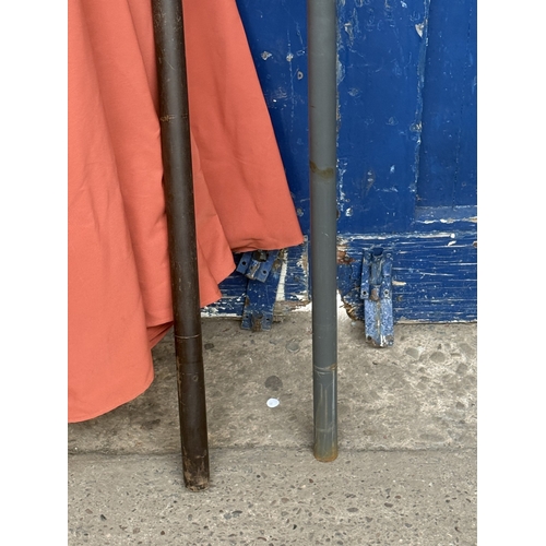 112 - Two garden parasols, one grey metal and beige fabric and one wood and orange fabric - approx. larges... 