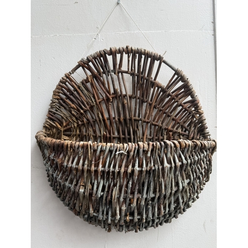 113 - Six wicker items, one carpet beater and five hanging baskets - approx. largest 65cm high x 62cm wide... 