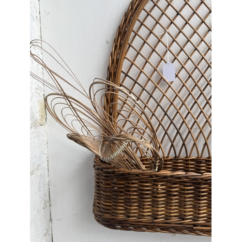 113 - Six wicker items, one carpet beater and five hanging baskets - approx. largest 65cm high x 62cm wide... 