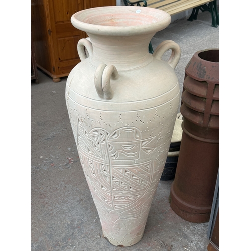 120 - A large painted terracotta floor standing three handled amphora vase - approx. 111cm high