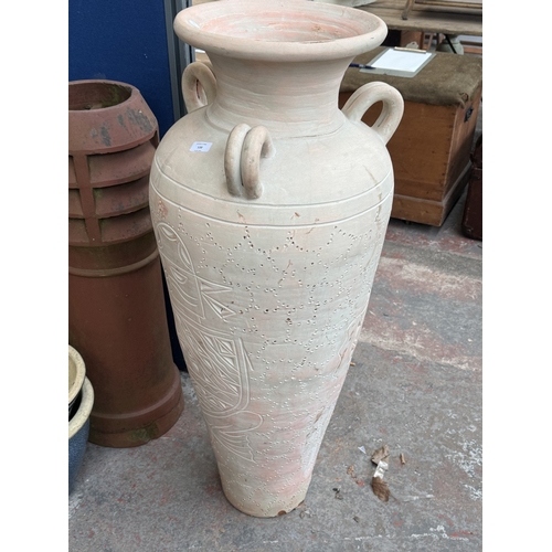120 - A large painted terracotta floor standing three handled amphora vase - approx. 111cm high