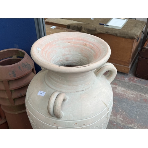 120 - A large painted terracotta floor standing three handled amphora vase - approx. 111cm high