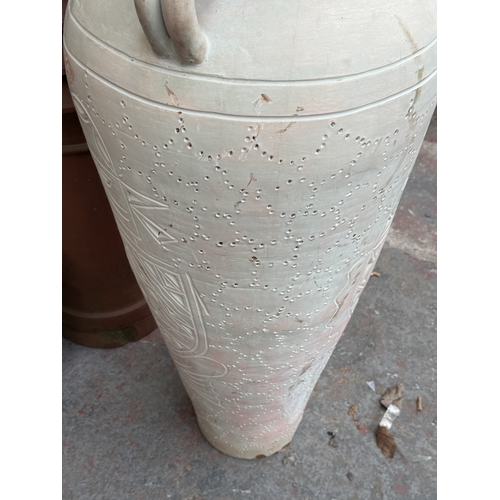120 - A large painted terracotta floor standing three handled amphora vase - approx. 111cm high