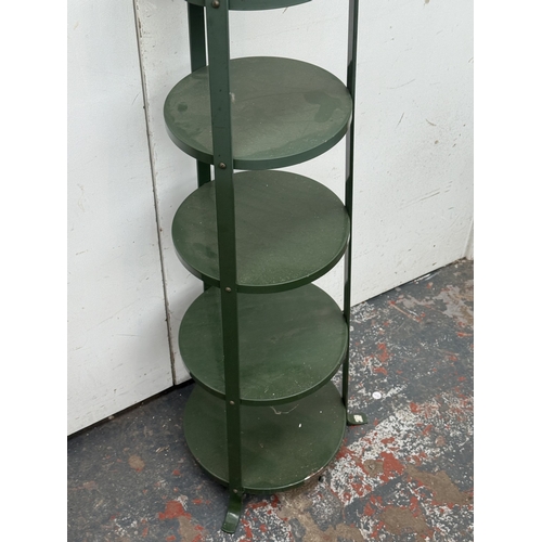 122 - A green metal six tier plant stand - approx. 126cm high