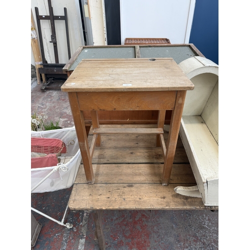 128 - Three pieces of furniture, one mid 20th century beech child's school desk, one antique white painted... 