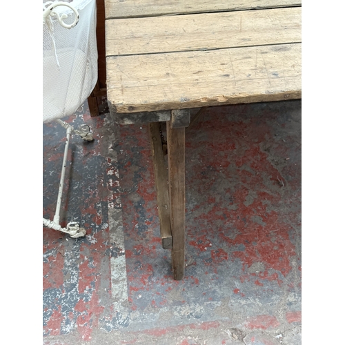 130 - An early 20th century pine folding trestle table - approx. 72cm high x 85cm wide x 182cm long
