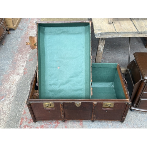 131 - Two pieces of furniture, one early 20th century brown painted and wooden banded travel trunk and one... 