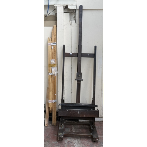 139 - A mid/late 20th century Victorian style stained beech artist's easel with later wooden canvas frame ... 