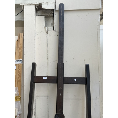 139 - A mid/late 20th century Victorian style stained beech artist's easel with later wooden canvas frame ... 