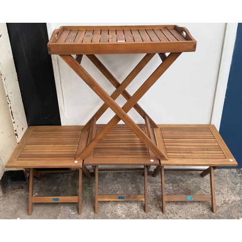 140 - Four stained teak folding garden side tables, three approx. 45cm high x 45cm square and one with rem... 