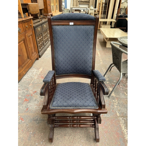 142 - Two pieces of mid/late 20th century mahogany and blue fabric upholstered furniture, one gout stool a... 