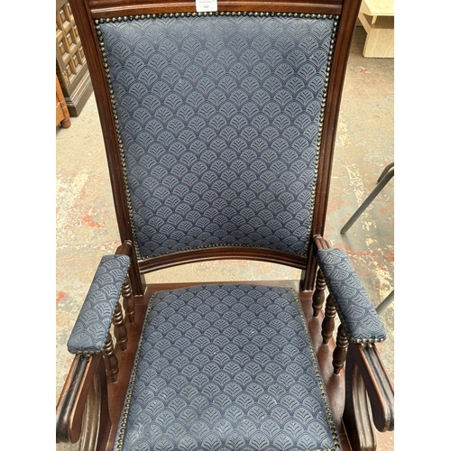 142 - Two pieces of mid/late 20th century mahogany and blue fabric upholstered furniture, one gout stool a... 