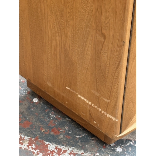 145 - An Ercol Windsor blonde elm and ash sideboard - approx. 93cm high x 156cm wide x 43cm deep