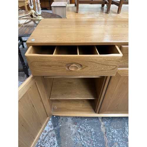 145 - An Ercol Windsor blonde elm and ash sideboard - approx. 93cm high x 156cm wide x 43cm deep