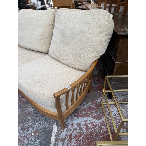 148 - An early Renaissance ash two-seater sofa with beige fabric cushioned cushions - approx. 93cm high x ... 