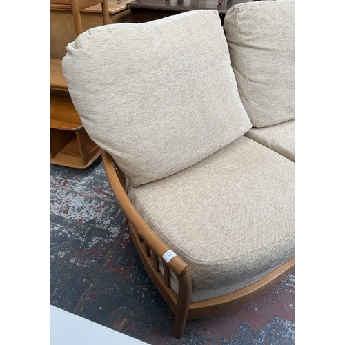 148 - An early Renaissance ash two-seater sofa with beige fabric cushioned cushions - approx. 93cm high x ... 