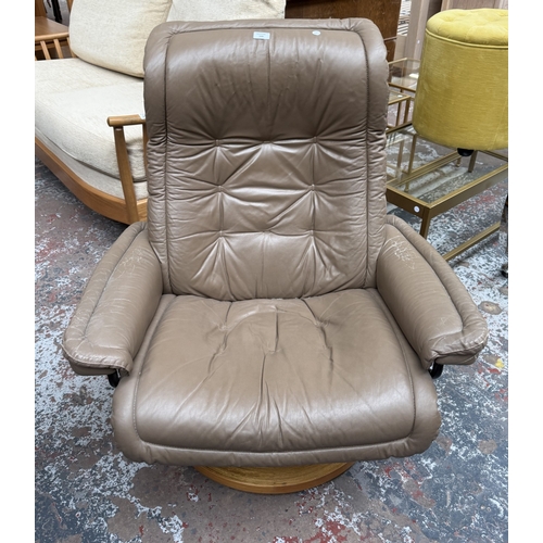 149 - An Ekornes Stressless tan leather and bentwood swivel reclining armchair - approx. 99cm high x 87cm ... 