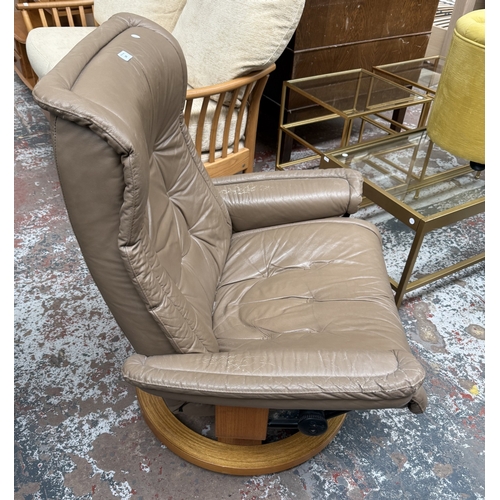149 - An Ekornes Stressless tan leather and bentwood swivel reclining armchair - approx. 99cm high x 87cm ... 
