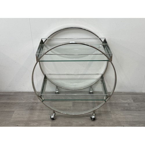 150 - An Art Deco style chrome plated and glass circular two-tier drinks trolley - approx. 80cm high x 74c... 