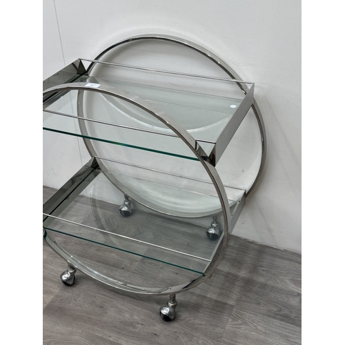 150 - An Art Deco style chrome plated and glass circular two-tier drinks trolley - approx. 80cm high x 74c... 