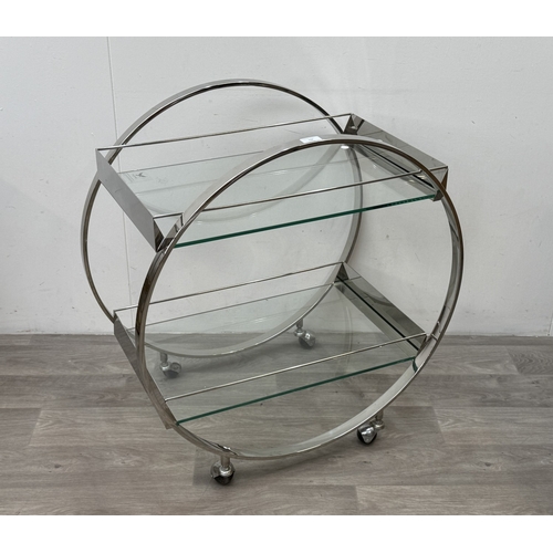 150 - An Art Deco style chrome plated and glass circular two-tier drinks trolley - approx. 80cm high x 74c... 