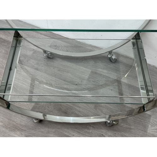 150 - An Art Deco style chrome plated and glass circular two-tier drinks trolley - approx. 80cm high x 74c... 