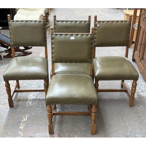 152 - Four Cromwellian style carved oak and tan vinyl upholstered dining chairs