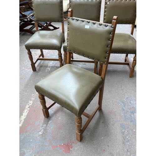 152 - Four Cromwellian style carved oak and tan vinyl upholstered dining chairs