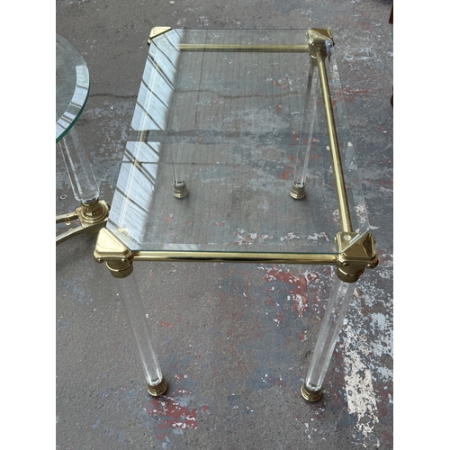 155 - Two Hollywood Regency style glass, brass and lucite side tables, one circular - approx. 50cm high x ... 