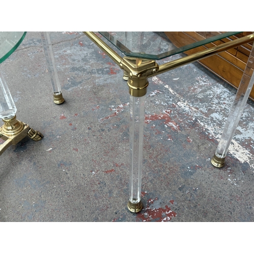 155 - Two Hollywood Regency style glass, brass and lucite side tables, one circular - approx. 50cm high x ... 