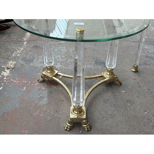 155 - Two Hollywood Regency style glass, brass and lucite side tables, one circular - approx. 50cm high x ... 