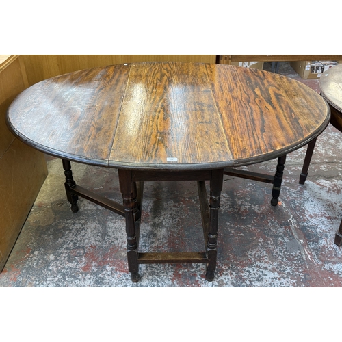 156 - An early 20th century oak drop-leaf gate-leg dining table - approx. 72cm high x 120cm wide x 150cm l... 