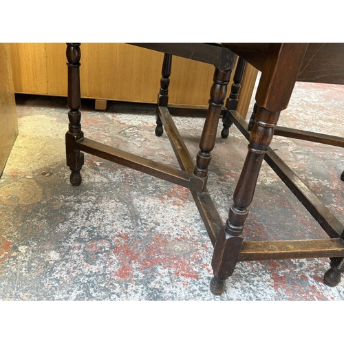 156 - An early 20th century oak drop-leaf gate-leg dining table - approx. 72cm high x 120cm wide x 150cm l... 