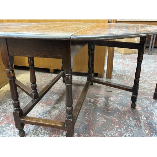156 - An early 20th century oak drop-leaf gate-leg dining table - approx. 72cm high x 120cm wide x 150cm l... 