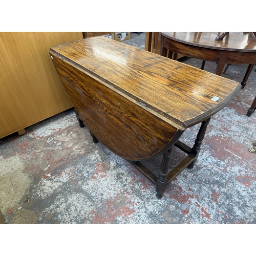 156 - An early 20th century oak drop-leaf gate-leg dining table - approx. 72cm high x 120cm wide x 150cm l... 