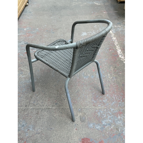 160 - A grey metal three-piece patio set comprising circular glass-top table and two plastic wicker effect... 