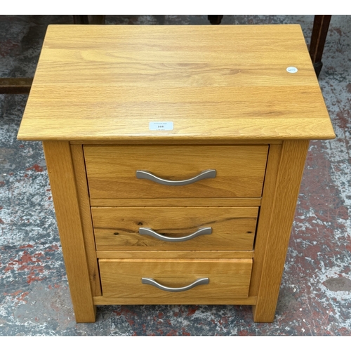 168 - A modern oak bedside chest of drawers - approx. 57cm high x 50cm wide x 35cm deep
