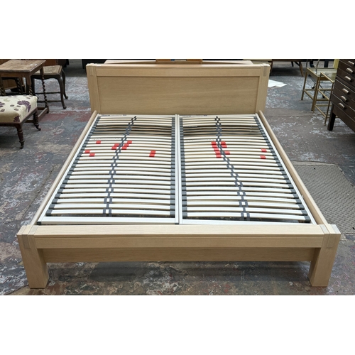 171 - A modern limed oak kingsize bedframe - approx. 80cm high x 172cm wide x 219cm deep