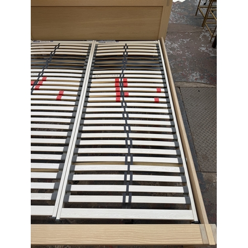 171 - A modern limed oak kingsize bedframe - approx. 80cm high x 172cm wide x 219cm deep