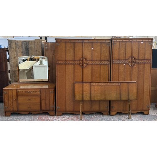 178 - A mid 20th century Austinsuite carved oak four piece bedroom suite comprising two double wardrobes, ... 