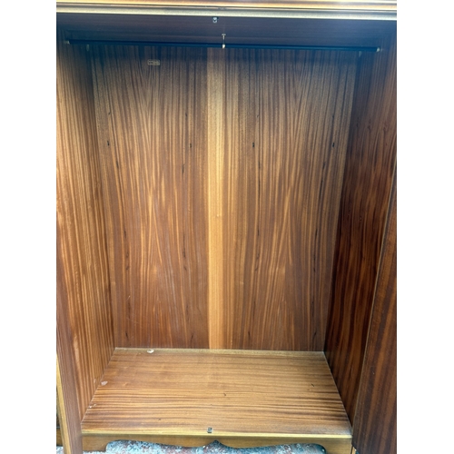 178 - A mid 20th century Austinsuite carved oak four piece bedroom suite comprising two double wardrobes, ... 