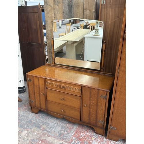 178 - A mid 20th century Austinsuite carved oak four piece bedroom suite comprising two double wardrobes, ... 