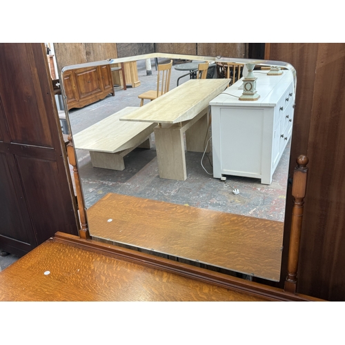 178 - A mid 20th century Austinsuite carved oak four piece bedroom suite comprising two double wardrobes, ... 